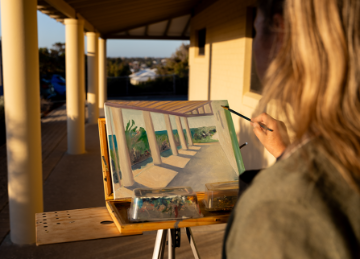 Image of woman painting in Mount Flora Regional Museum